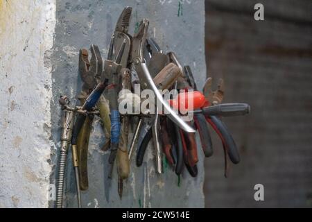 Tools hanging on the wall close up Stock Photo