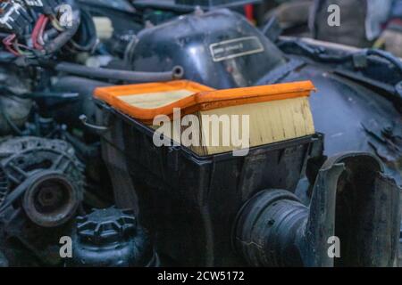 close-up of old orange air filter on car, repair concept Stock Photo