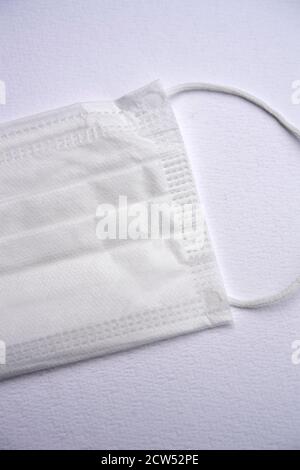 White protective face mask isolated on a white background Stock Photo