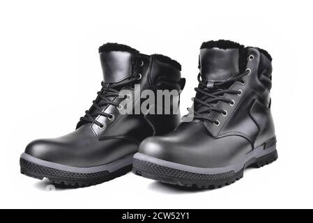 Winter men’s black leather boots on a white background, hiking shoes, practical off-road shoes, close-up isolate Stock Photo