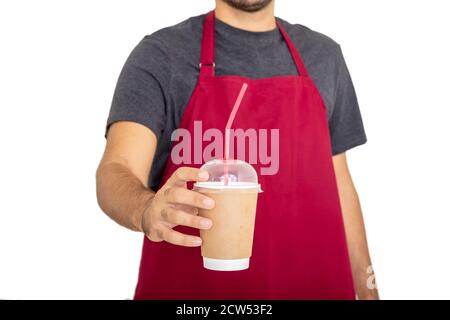 Barista in red apron holding coffee takeaway paper cup isolated against white background. Coffee to go at cafe shop concept, blank container, template Stock Photo
