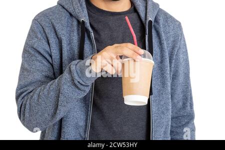 Man with coffee. Body of young person wearing blue hooded sweatshirt with zip drinks fresh beverage from paper container with straw isolated on white Stock Photo