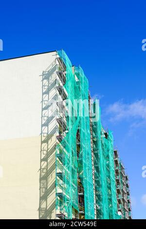 scaffolding arround the house to install thermal insulation of the apartment building facade Stock Photo