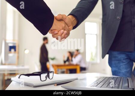 Close up of a process of handshake of two business people to secure a successful deal. Stock Photo