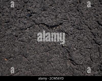 Cracked and damaged old asphalt road detail. Pattern of asphalt road texture background Stock Photo