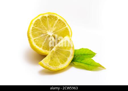 Lemon with lemon slice and leaves isolated on a white background. Stock Photo