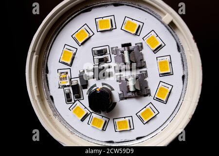 Broken fluorescent light bulb on wooden table Stock Photo