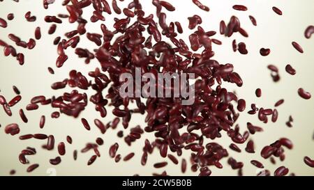 Raw red beans hitting up in the air, isolated on white background Stock Photo