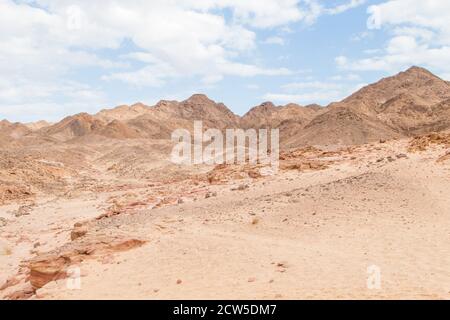 Desert, red mountains, rocks and cloudy sky. Egypt, color canyon, the Sinai Peninsula, Dahab. Stock Photo