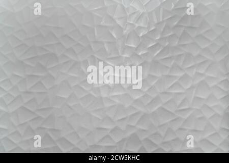 Background texture of a white ceramic wall with triangular goemetricals shapes. Stock Photo