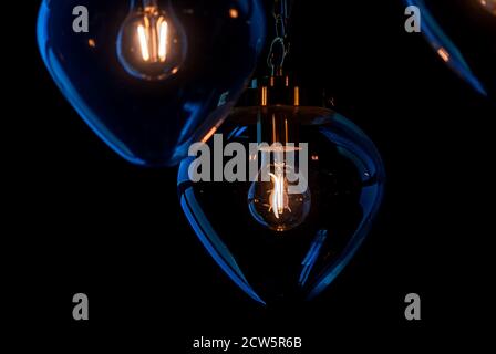 glass lamp shades in the dark Stock Photo