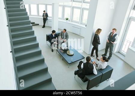 Small groups of business partners discussing points of reports after conference Stock Photo