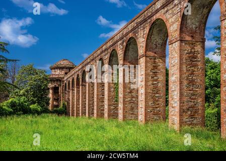 Ancient architecture in Tuscany. The stone temple-cistern of Lucca old aqueduct ruins built in neoclassical style in 1823 Stock Photo