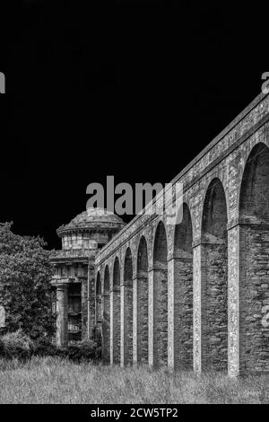 Ancient architecture in Tuscany. The stone temple-cistern of Lucca old aqueduct ruins built in neoclassical style in 1823 (Black and White with copy s Stock Photo