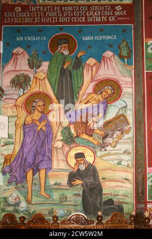 The Christian Orthodox Nechit Monastery, in Neamt County, Romania. Fresco depicting scenes from the life of St. Mary of Egypt and St. Zosimas. Stock Photo