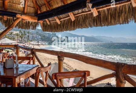 Restaurants and cafes with ocean views on Playa De Los Muertos beach and pier close to famous Puerto Vallarta Malecon, the city largest public beach Stock Photo