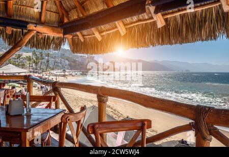 Restaurants and cafes with ocean views on Playa De Los Muertos beach and pier close to famous Puerto Vallarta Malecon, the city largest public beach Stock Photo