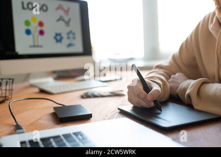 Hands of young creative male freelance designer using touchpad and stylus Stock Photo