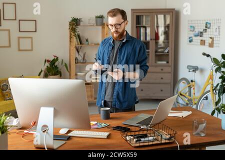 Young creative software developer or designer drawing on tablet display Stock Photo