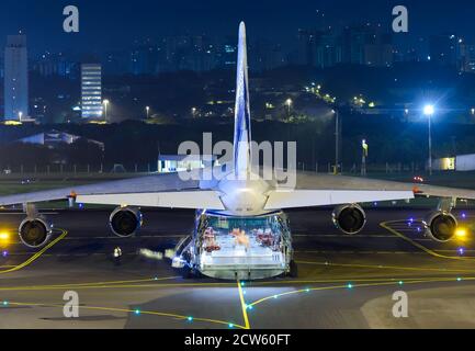 Volga Dnepr Airlines Antonov An 124 aircraft from behind at night at Porto Alegre, Brazil. Cargo hold compartment door open of Antonov 124 aircraft. Stock Photo