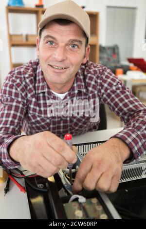 electrician testing appliance with electrical screwdriver Stock Photo