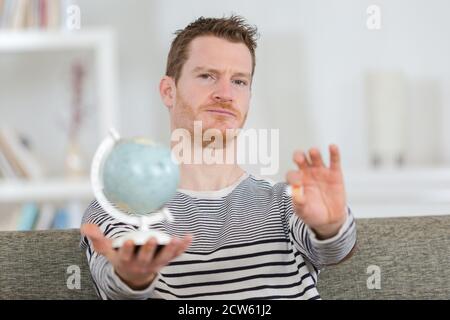 portrait of man holding globe and sim card Stock Photo