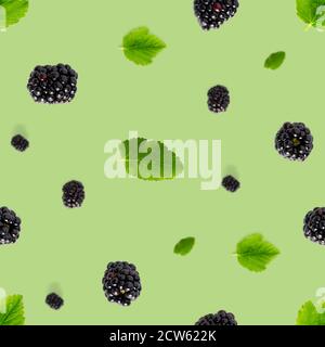 Falling Bramble Seamless pattern. Fresh Falling blackberry seamless pattern. Pattern with fresh wild berries isolated on green background. Stock Photo