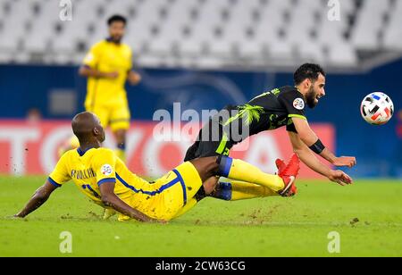 Doha, Qatar. 27th Sep, 2020. Sultan Mandash (R) of Taawoun FC competes during the AFC Asian Champions League round of 16 football match between Taawoun FC and Al Nassr of Saudi Arabia at Education City Stadium in Doha, Qatar, Sept. 27, 2020. Credit: Nikku/Xinhua/Alamy Live News Stock Photo