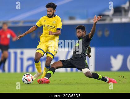 Doha, Qatar. 27th Sep, 2020. Yaseen Barnawi (R) of Taawoun FC vies with Khalid Al-Ghannam of Al Nassr during the AFC Asian Champions League round of 16 football match between Taawoun FC and Al Nassr of Saudi Arabia at Education City Stadium in Doha, Qatar, Sept. 27, 2020. Credit: Nikku/Xinhua/Alamy Live News Stock Photo