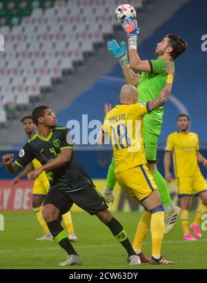 Doha, Qatar. 27th Sep, 2020. Al Nassr's goalkeeper Brad Jones (top) catches the ball during the AFC Asian Champions League round of 16 football match between Taawoun FC and Al Nassr of Saudi Arabia at Education City Stadium in Doha, Qatar, Sept. 27, 2020. Credit: Nikku/Xinhua/Alamy Live News Stock Photo