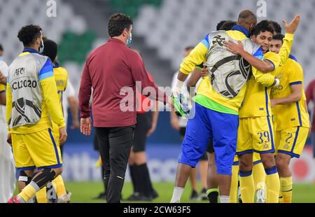 Doha, Qatar. 27th Sep, 2020. Al Nassr's players celebrate their victory after the AFC Asian Champions League round of 16 football match between Taawoun FC and Al Nassr of Saudi Arabia at Education City Stadium in Doha, Qatar, Sept. 27, 2020. Credit: Nikku/Xinhua/Alamy Live News Stock Photo