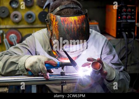 TIG welding of polished stainless steel pipe Stock Photo