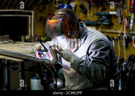 TIG welding of polished stainless steel pipe Stock Photo