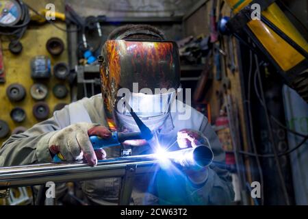 TIG welding of polished stainless steel pipe Stock Photo