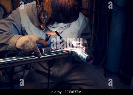 TIG welding of polished stainless steel pipe Stock Photo