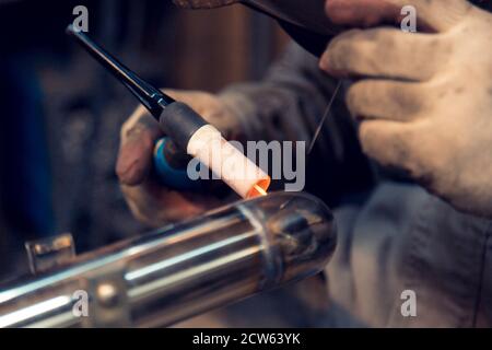 TIG welding of polished stainless steel pipe Stock Photo