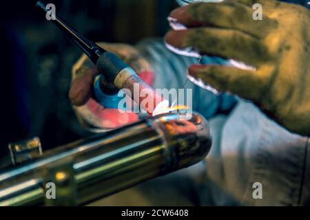 TIG welding of polished stainless steel pipe Stock Photo