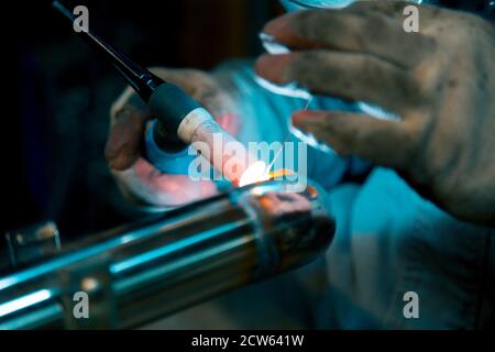 TIG welding of polished stainless steel pipe Stock Photo