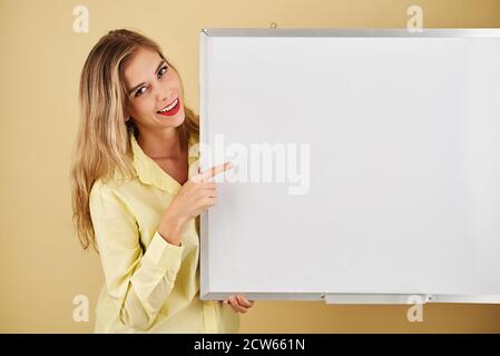 Woman pointing at whiteboard Stock Photo