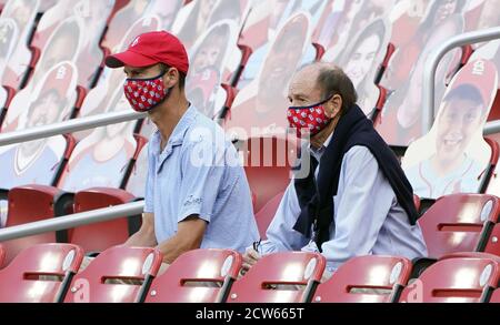 St. Louis Cardinals President Bill DeWitt III (R) points out the