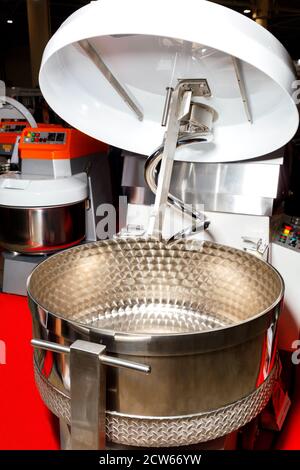 Large kneader made of stainless steel for professional production of dough and various food mixtures, close-up. Stock Photo