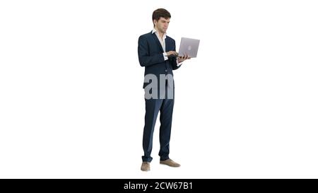 Concentrated young businessman working on laptop while standing Stock Photo