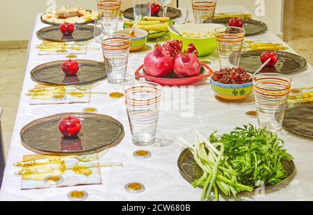 Festively decorated table for Rosh Hashanah with pomegranates and apples. Stock Photo