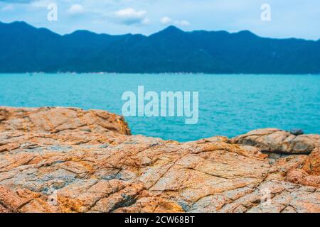 Panorama view shabby cliff cumulus cloud sky mountain island background pure blue lazure empty sea skyline. Gray brown stone rock texture vivid colour Stock Photo