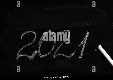 writing 2021 on black chalkboard, closeup Stock Photo