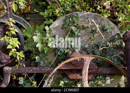 A large vintage grindstone for tool sharpening rusting in a farmyard in Cumbria Stock Photo