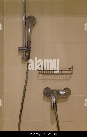 Shower cabin in a bathroom. Modern bathroom in the middle class hotel. Soft beige colors of design. Concept of comfortable business trip Stock Photo