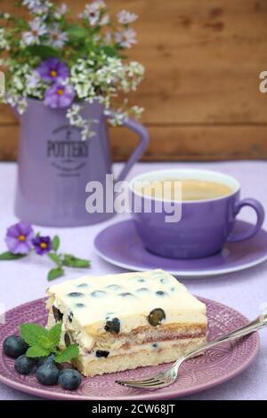 cake tiramisu with fresh blueberries and cup of coffee Stock Photo