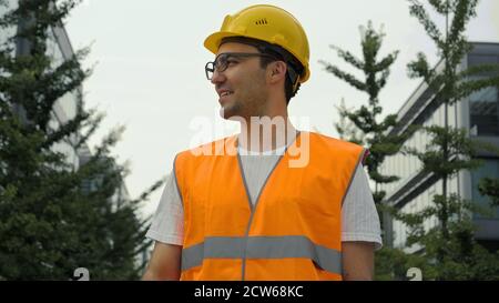 Young engineer in glasses smiling wear a safety helmet being hap Stock Photo