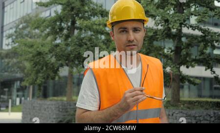 Male Industrial Engineer in Hard Hat and Safety Jacket Walking A Stock Photo